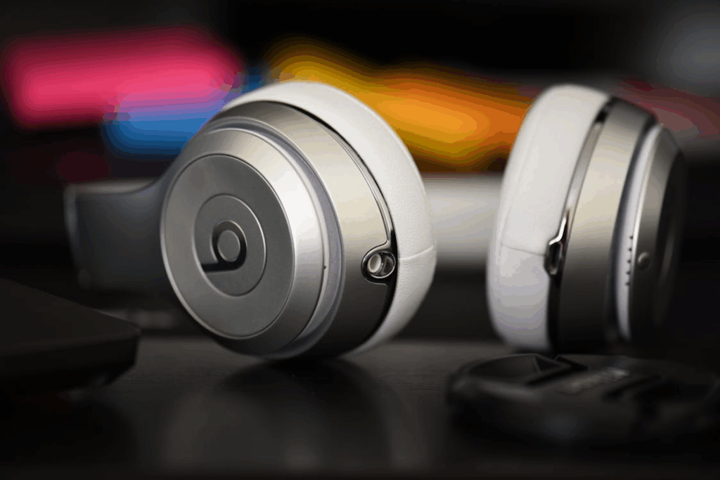 Close-up of silver Beats noise-canceling headphones on a desk