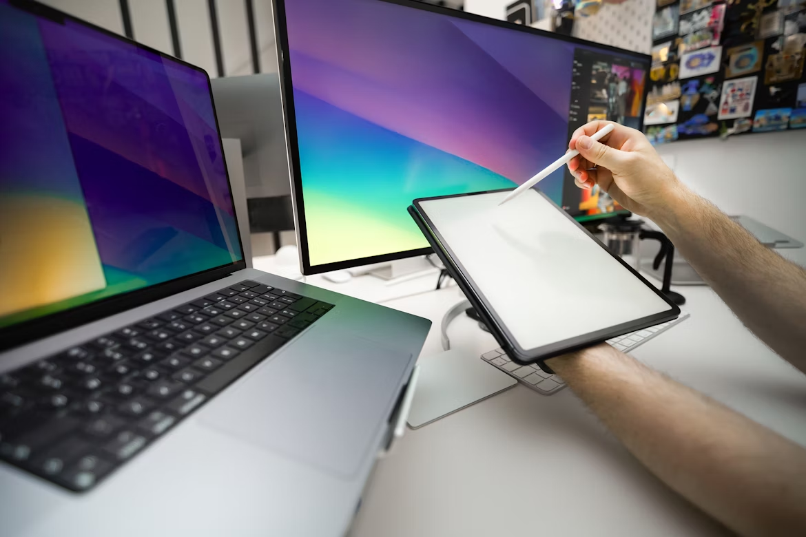 Comparing a tablet with stylus and a laptop on a desk, showing tablet vs laptop for everyday use